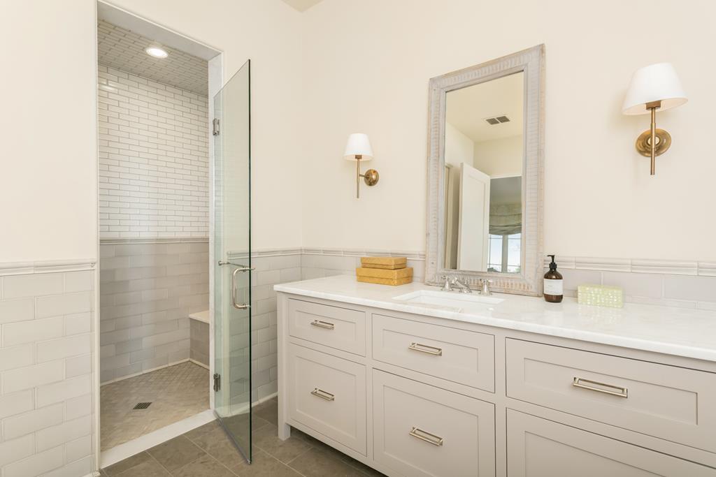 1691 Cool Water Ranch Road Fredericksburg, TX 78624 - Photo 27 of 33 a bathroom with a shower sink and mirror