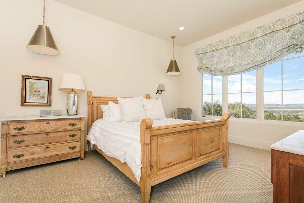 1691 Cool Water Ranch Road Fredericksburg, TX 78624 - Photo 28 of 33 a bed room with a bed and a window