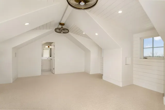 a bathroom with a granite countertop toilet sink and mirror