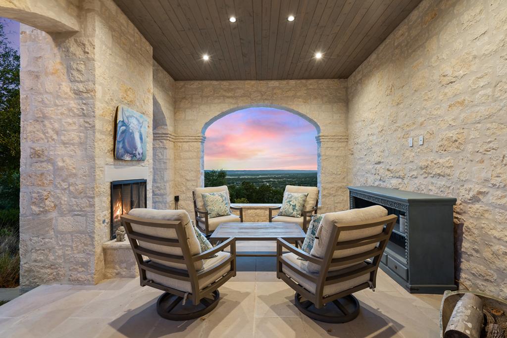 1691 Cool Water Ranch Road Fredericksburg, TX 78624 - Photo 9 of 33 a living room with furniture a fireplace and a flat screen tv