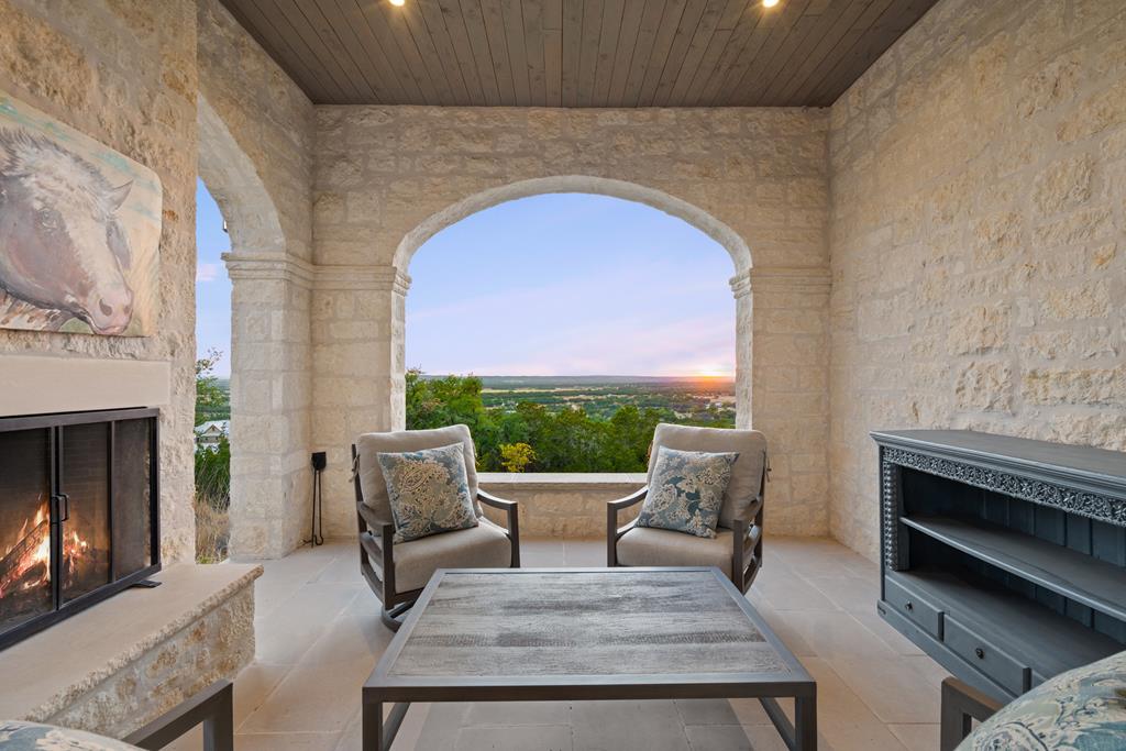 1691 Cool Water Ranch Road Fredericksburg, TX 78624 - Photo 10 of 33 a living room with furniture and a fireplace