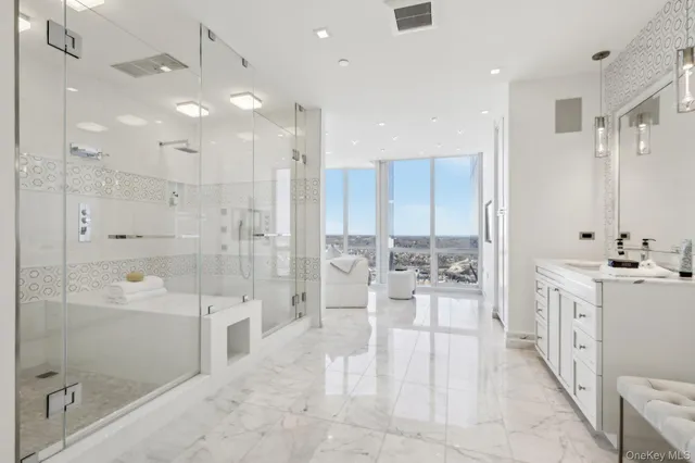 a large bathroom with a glass shower door a sink a bathtub and shower