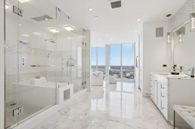 a large bathroom with a glass door shower a sink and a mirror