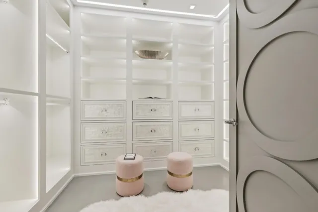 a bathroom with a toilet and a glass door shower