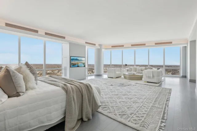 a large bedroom with a bed and a couch