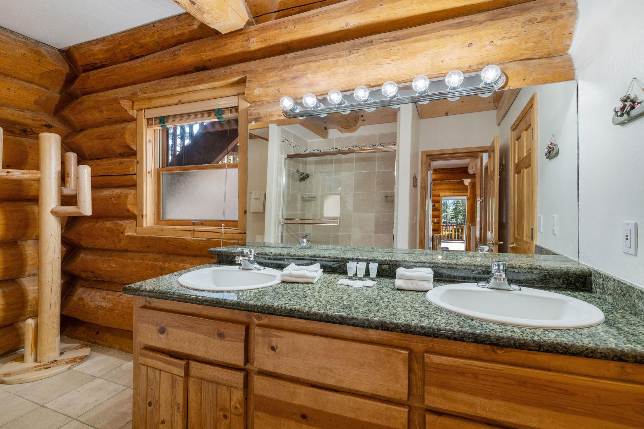 7883 Mashie Avenue Tahoe Vista, CA 96148 - Photo 13 of 28 a bathroom with a granite countertop sink and a mirror