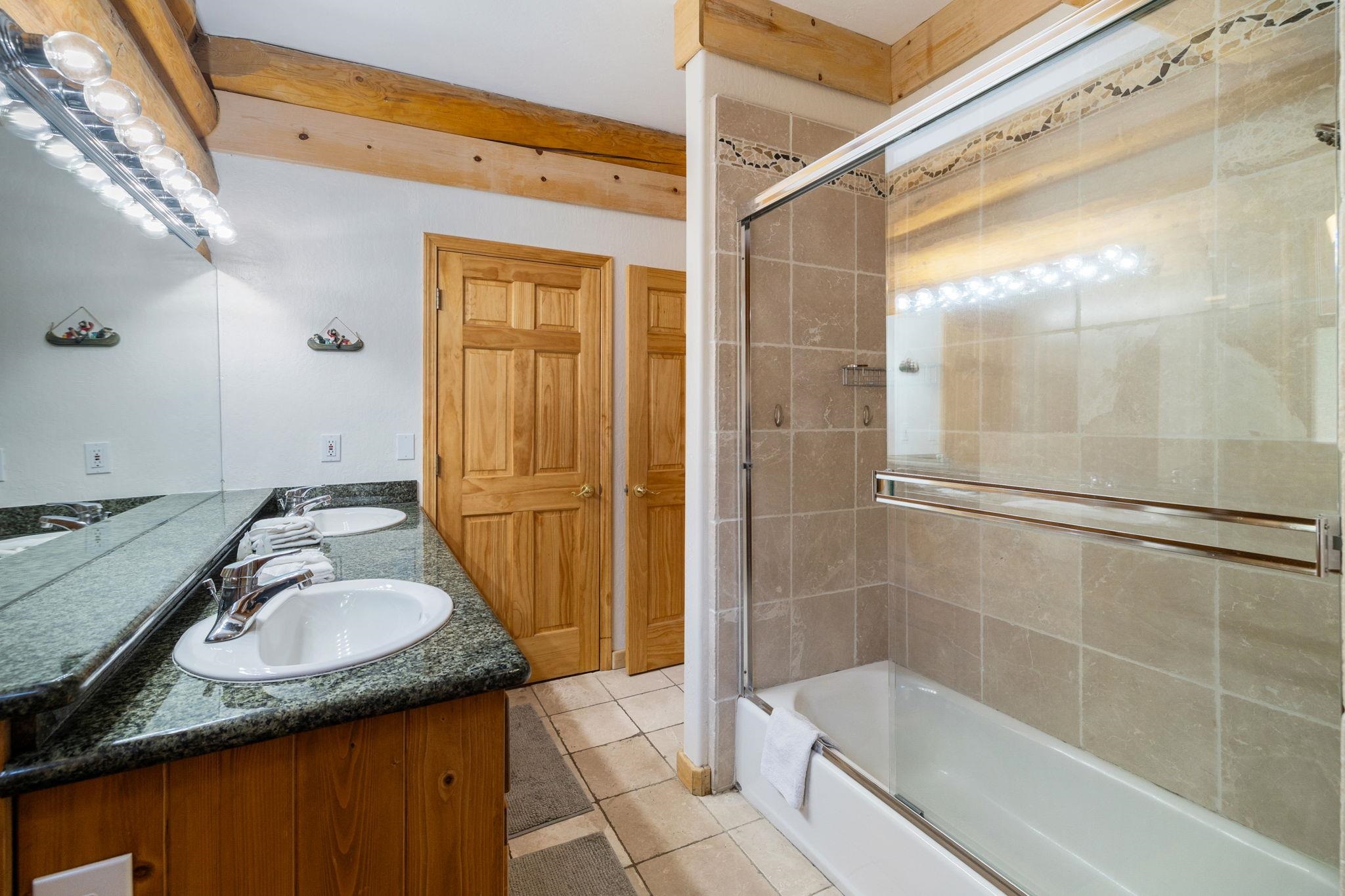 7883 Mashie Avenue Tahoe Vista, CA 96148 - Photo 14 of 28 a bathroom with a granite countertop sink mirror and shower