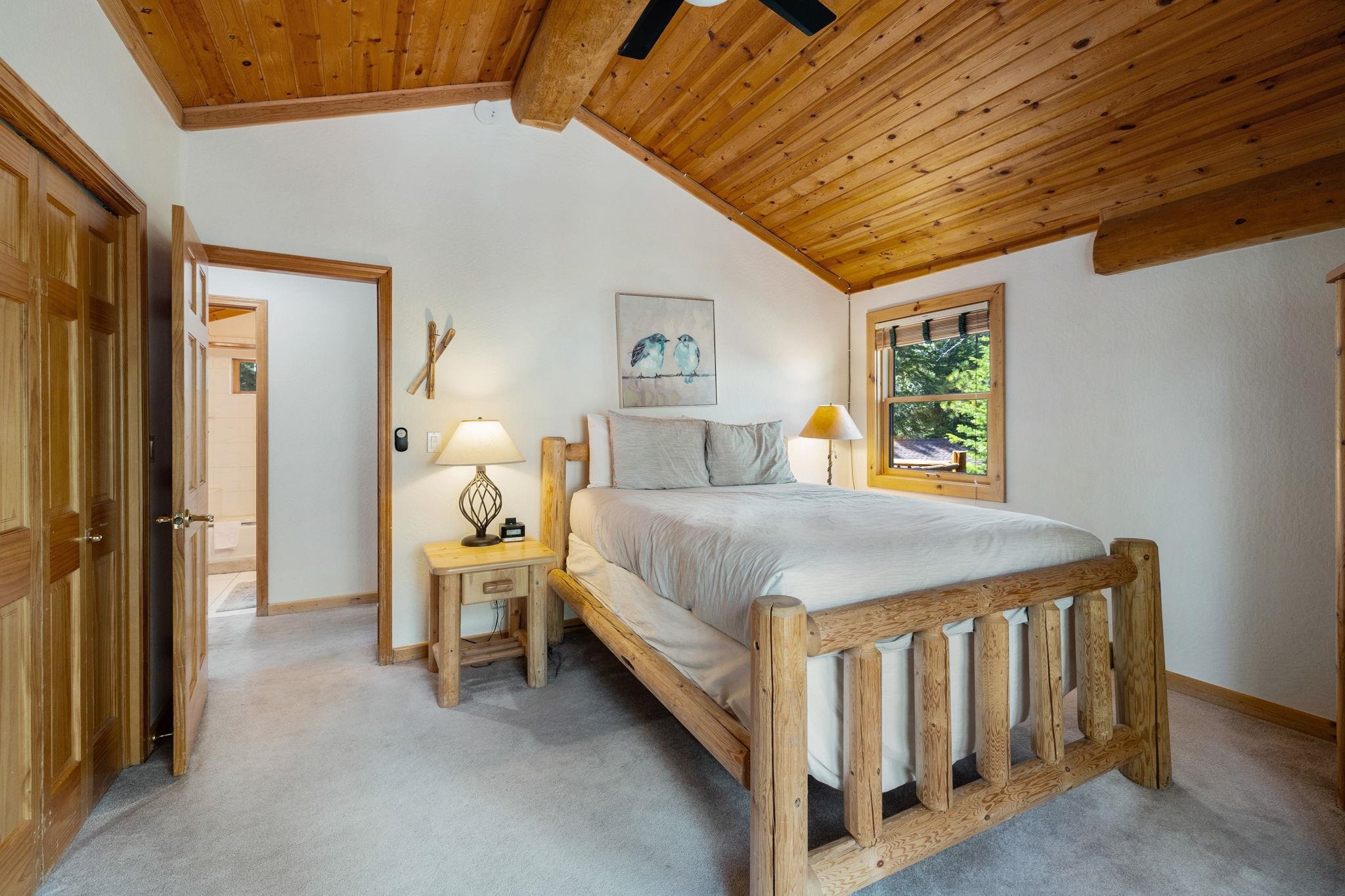 7883 Mashie Avenue Tahoe Vista, CA 96148 - Photo 19 of 28 a bed sitting in a bedroom next to a window