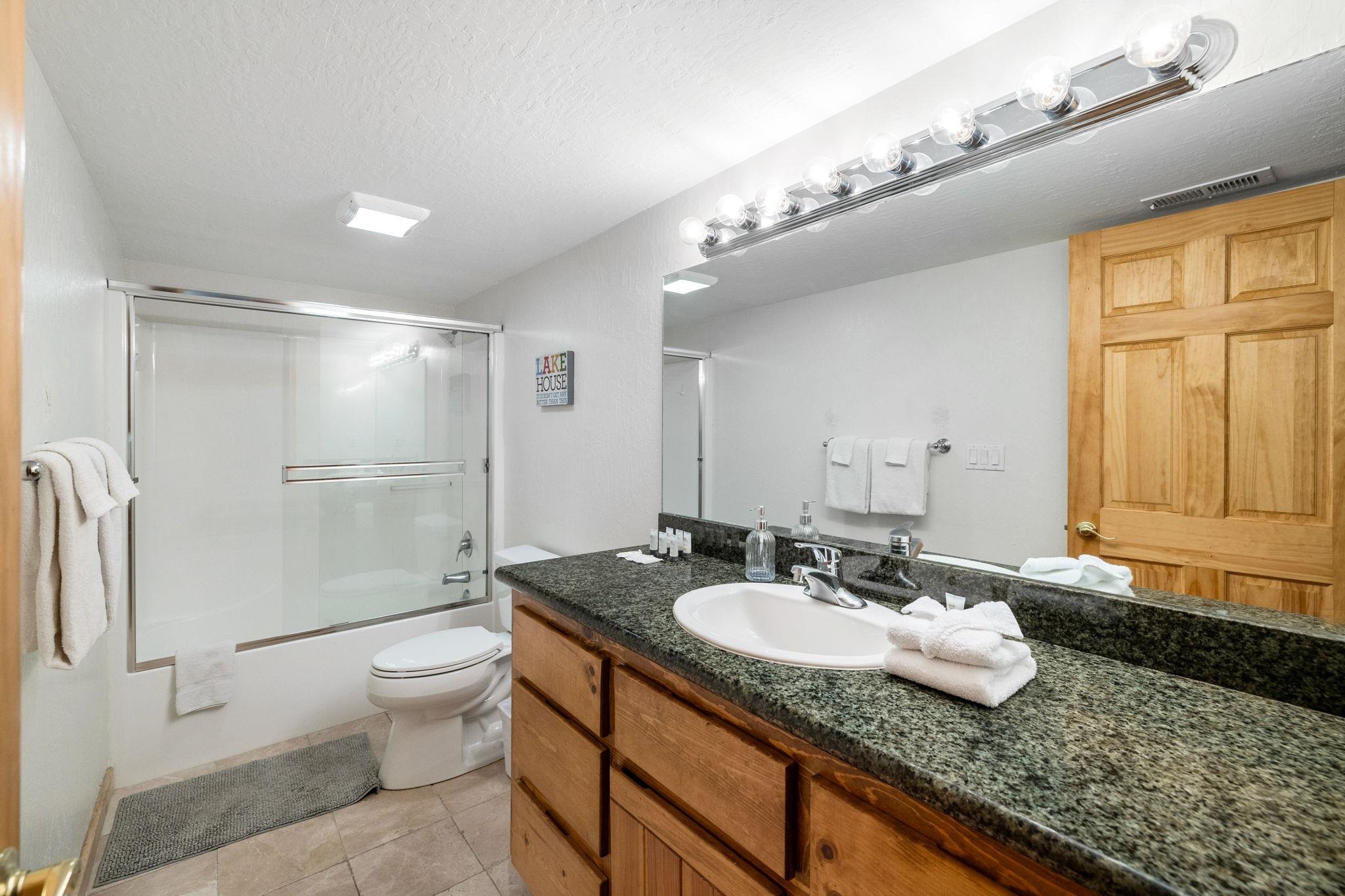 7883 Mashie Avenue Tahoe Vista, CA 96148 - Photo 23 of 28 a bathroom with a granite countertop sink and a mirror