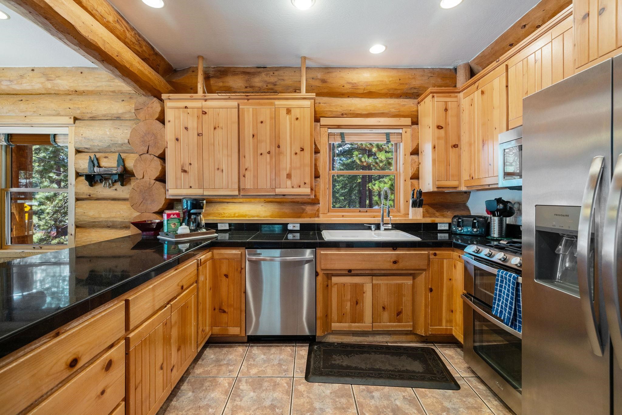 7883 Mashie Avenue Tahoe Vista, CA 96148 - Photo 7 of 28 a kitchen with stainless steel appliances a stove a sink and a refrigerator