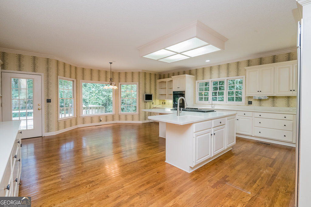 106 Baymeadow Point Savannah, GA 31405 - Photo 4 of 30 a large kitchen with kitchen island a large window a sink and cabinets