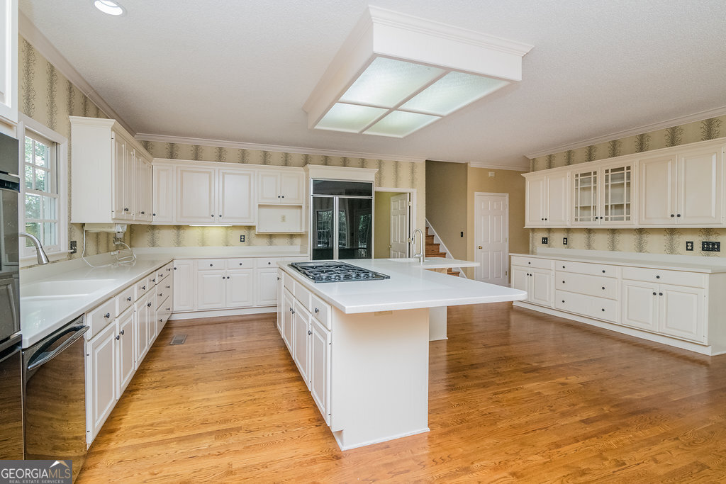 106 Baymeadow Point Savannah, GA 31405 - Photo 5 of 30 a large kitchen with kitchen island a sink a stove and cabinets