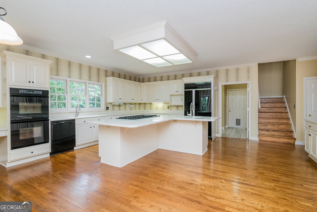 106 Baymeadow Point Savannah, GA 31405 - Photo 9 of 30 a kitchen with stainless steel appliances granite countertop a stove a sink and a refrigerator