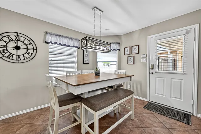 a kitchen with stainless steel appliances granite countertop white cabinets and black stove top oven