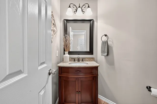 a bathroom with a double vanity sink and a mirror