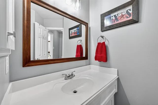 a bedroom with a bed and a large mirror with a large window