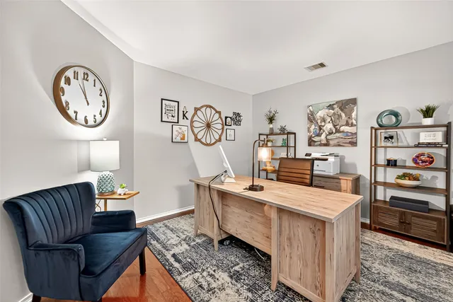 a living room with furniture and wall paintings