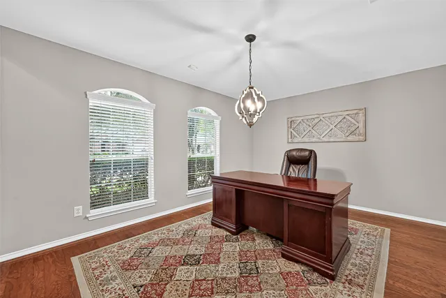 a view of a workspace with furniture and window