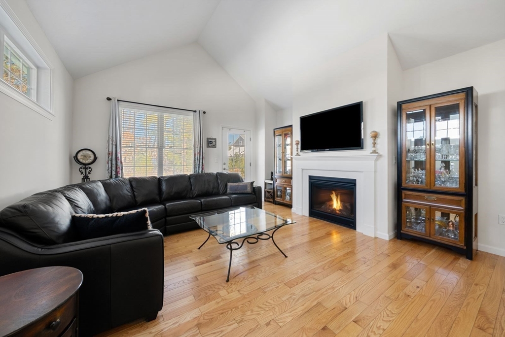 44 Mariners Way, Unit 44 Plymouth, MA 02360 - Photo 11 of 36 a living room with furniture a flat screen tv and a fireplace
