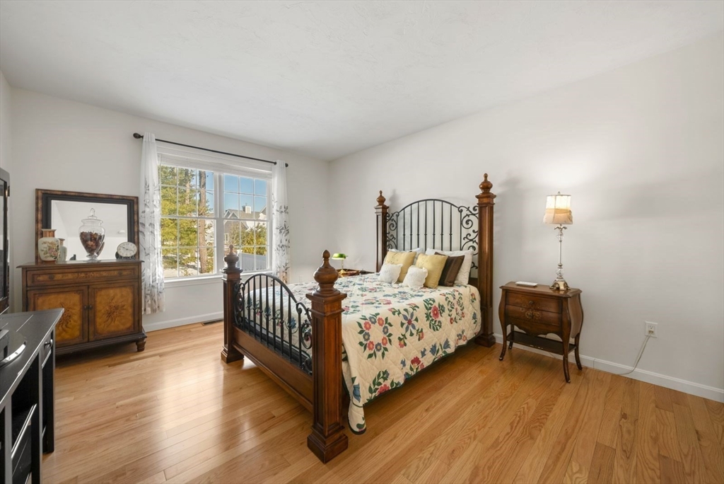 44 Mariners Way, Unit 44 Plymouth, MA 02360 - Photo 18 of 36 a bedroom with a bed and wooden floor