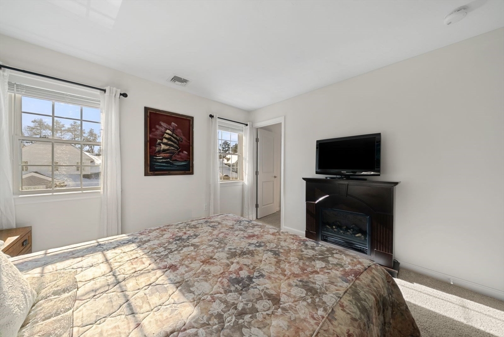 44 Mariners Way, Unit 44 Plymouth, MA 02360 - Photo 25 of 36 a bedroom with a bed and a flat screen tv