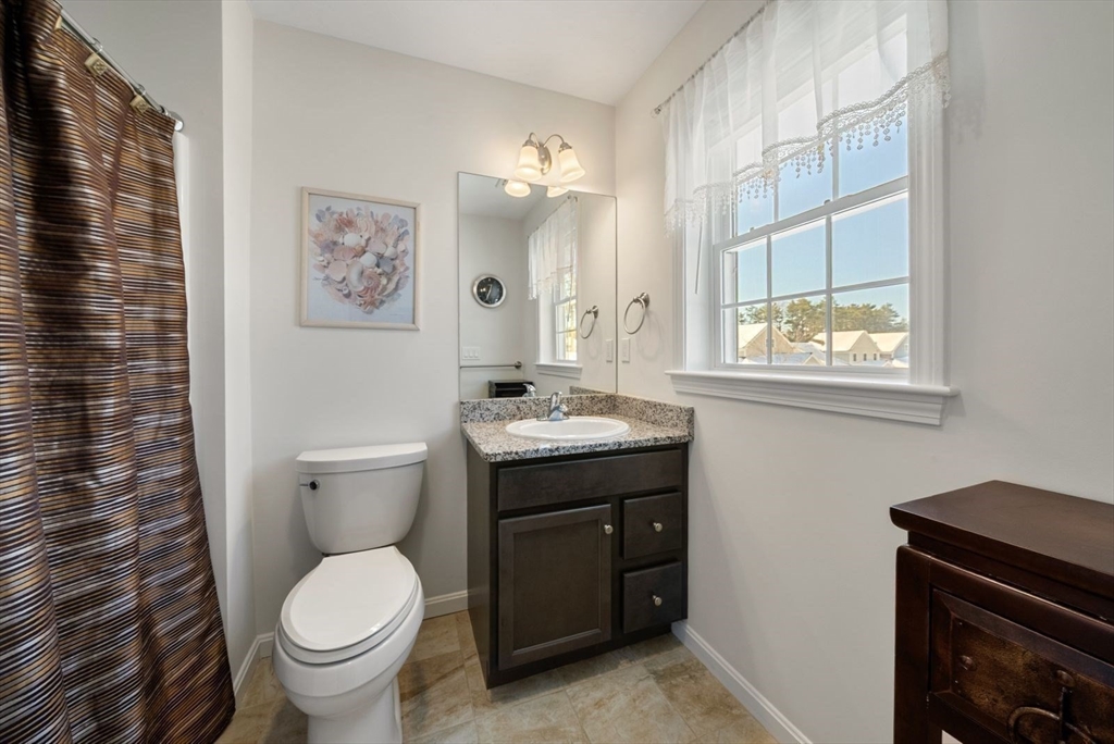 44 Mariners Way, Unit 44 Plymouth, MA 02360 - Photo 28 of 36 a bathroom with a granite countertop toilet sink and mirror