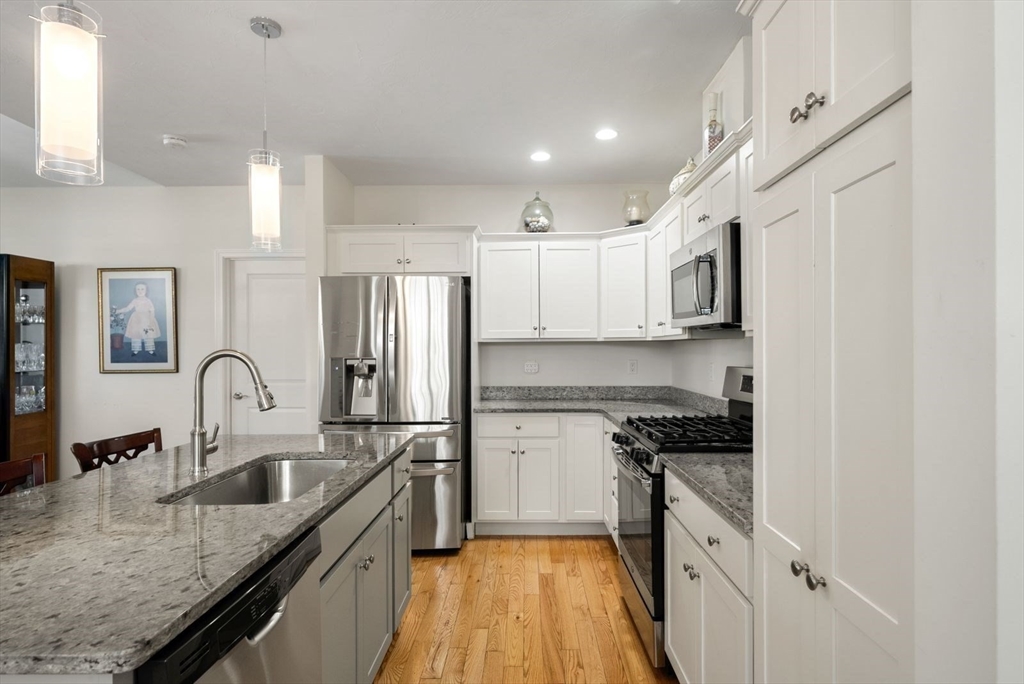44 Mariners Way, Unit 44 Plymouth, MA 02360 - Photo 8 of 36 a kitchen with kitchen island granite countertop a sink stainless steel appliances and window