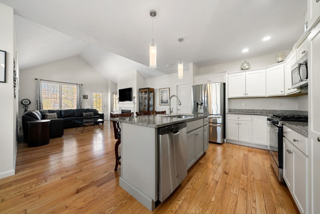 44 Mariners Way, Unit 44 Plymouth, MA 02360 - Photo 9 of 36 a large kitchen with kitchen island a large counter top space a sink stainless steel appliances and cabinets