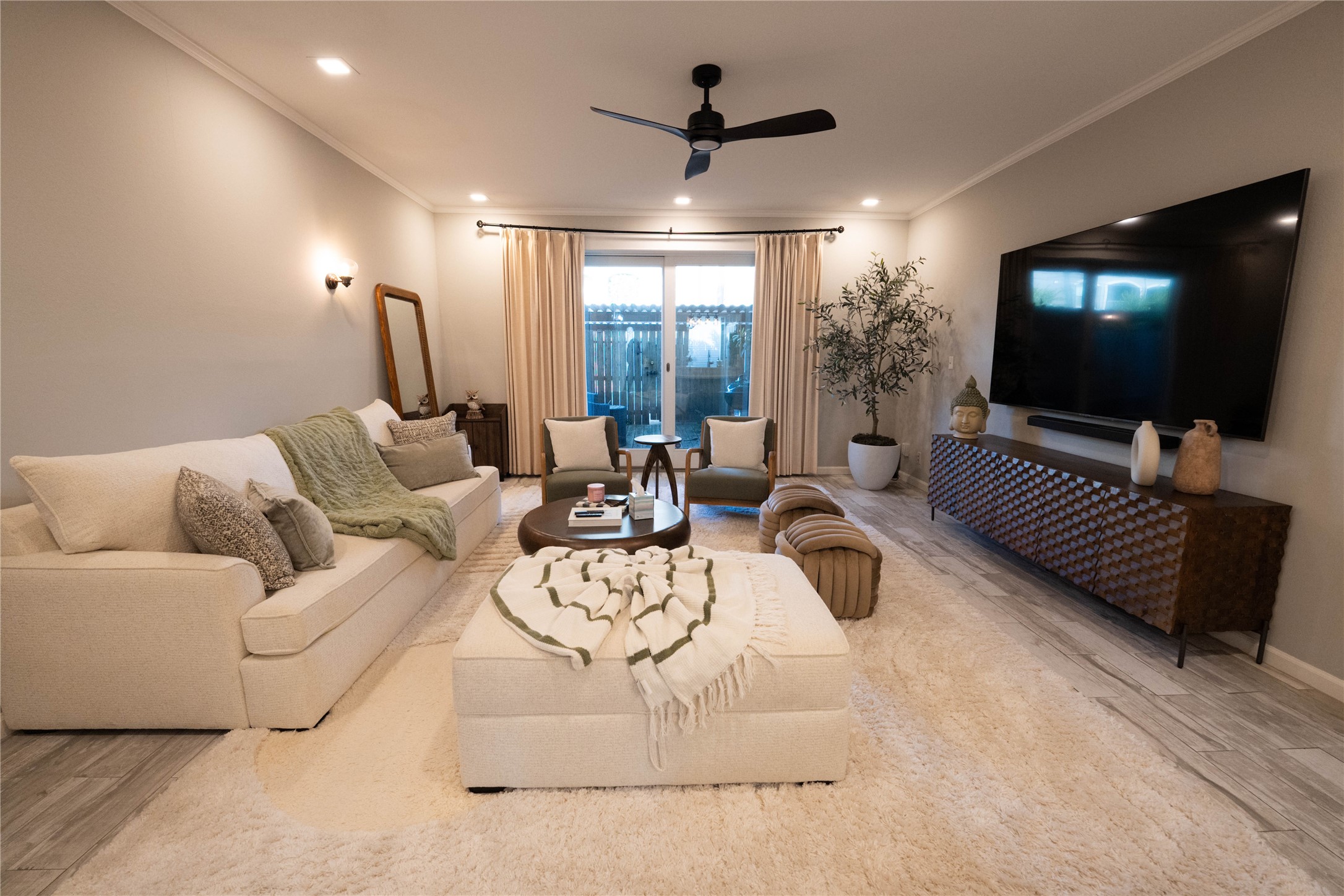 7447 Brompton Street, Unit 7447 Houston, TX 77025 - Photo 5 of 27 Warm and welcoming living room featuring hardwood floors and easy access to the back patio.