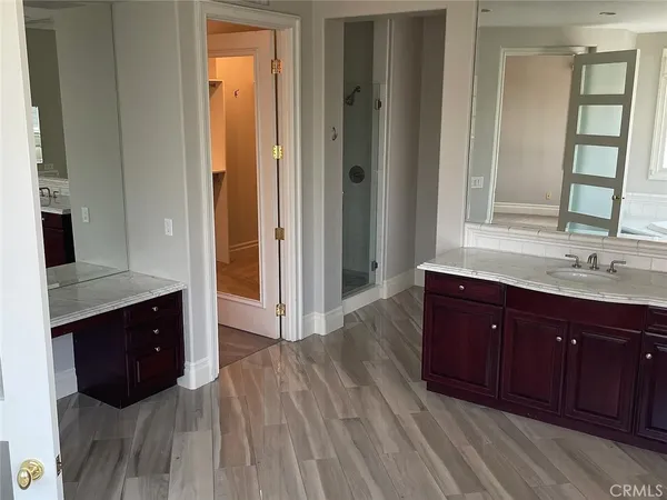 a spacious bathroom with a sink and a mirror