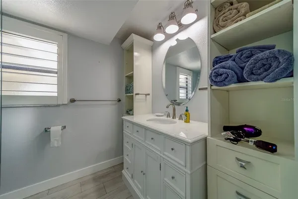 a spacious bedroom with a bed and a flat screen tv