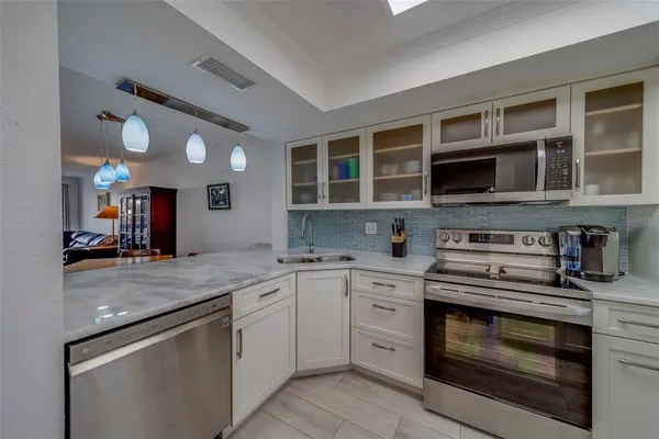 a kitchen with a sink stove and microwave