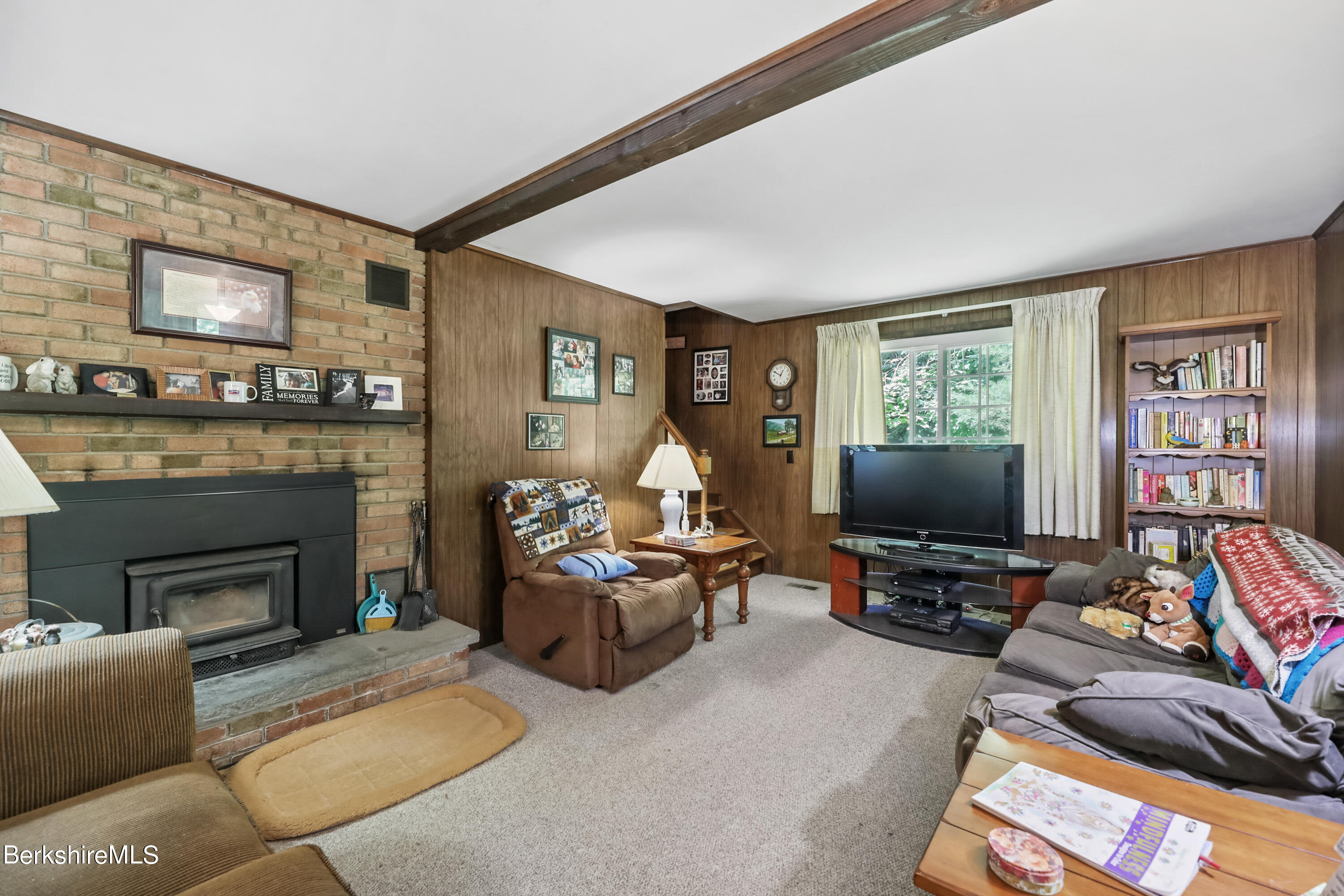 2375 North Main Road Otis, MA 01253 - Photo 17 of 31 a living room with furniture a flat screen tv and a fireplace