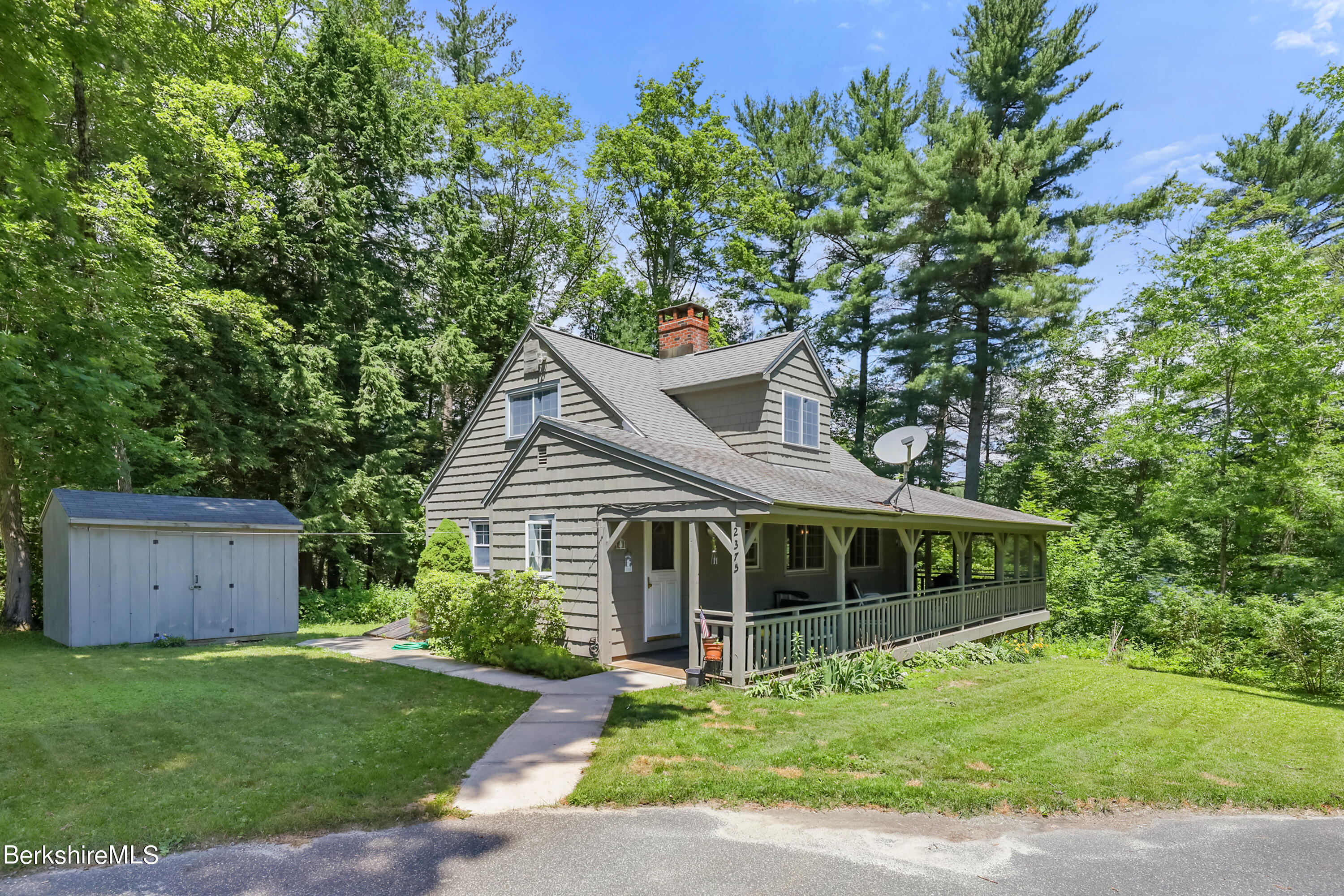 2375 North Main Road Otis, MA 01253 - Photo 2 of 31 a front view of a house with a garden
