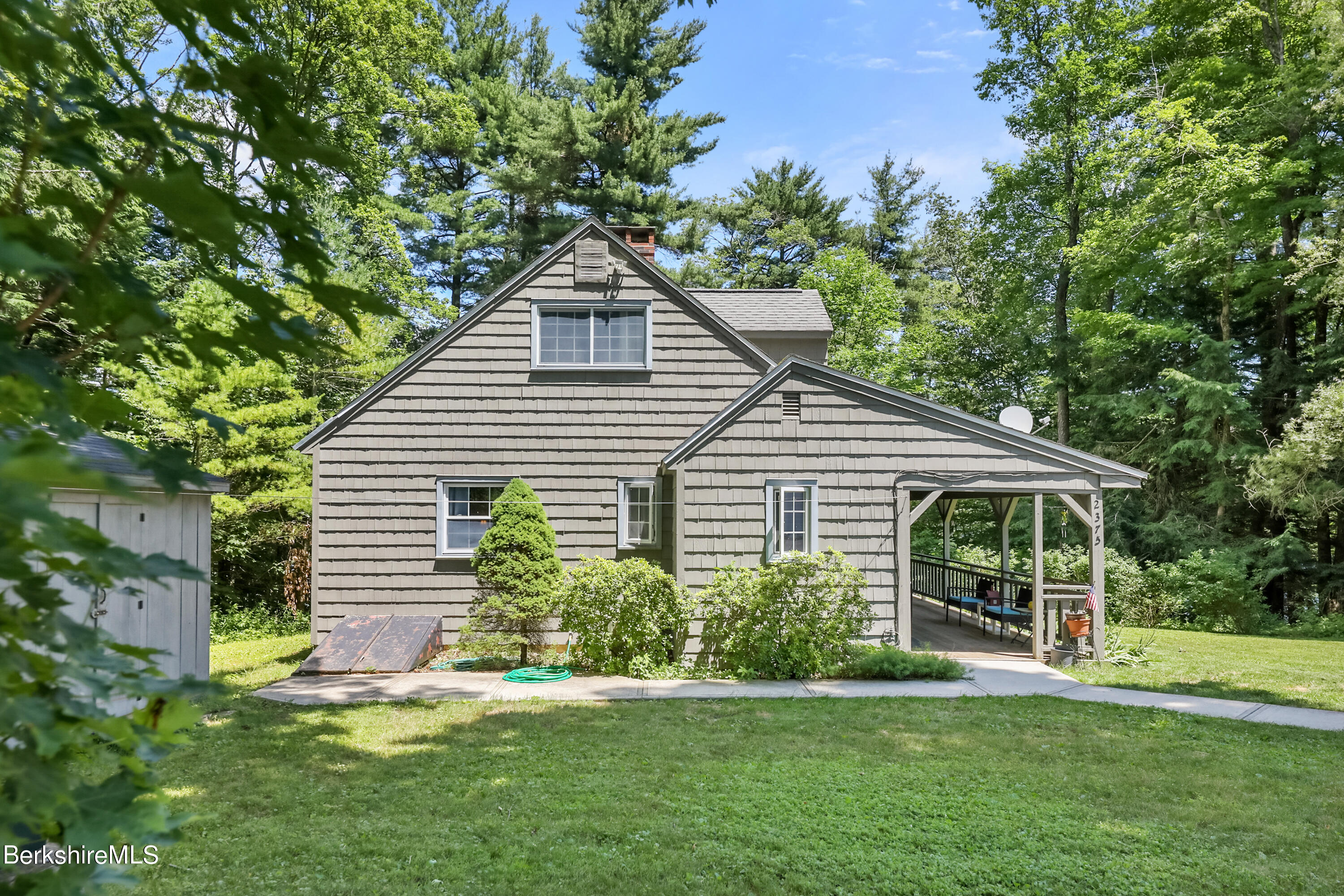 2375 North Main Road Otis, MA 01253 - Photo 3 of 31 a front view of a house with a yard