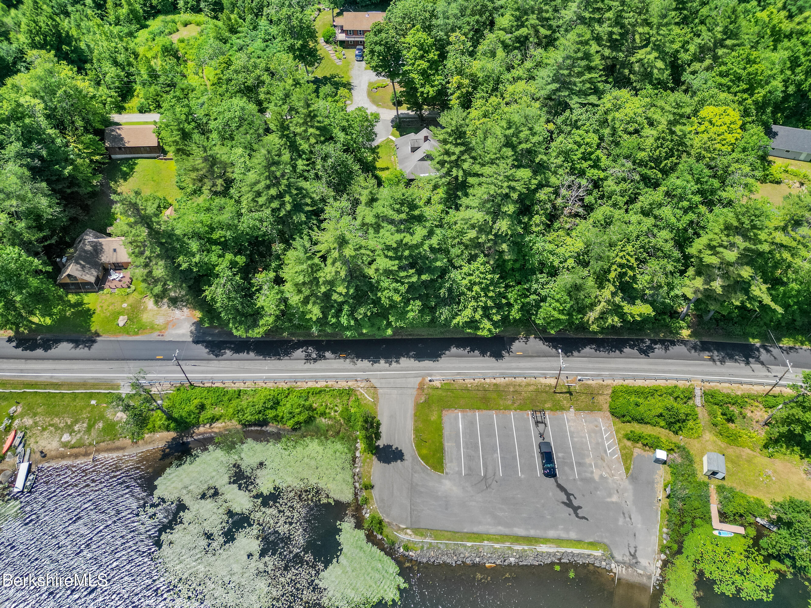 2375 North Main Road Otis, MA 01253 - Photo 31 of 31 a view of a swimming pool with a patio and a garden