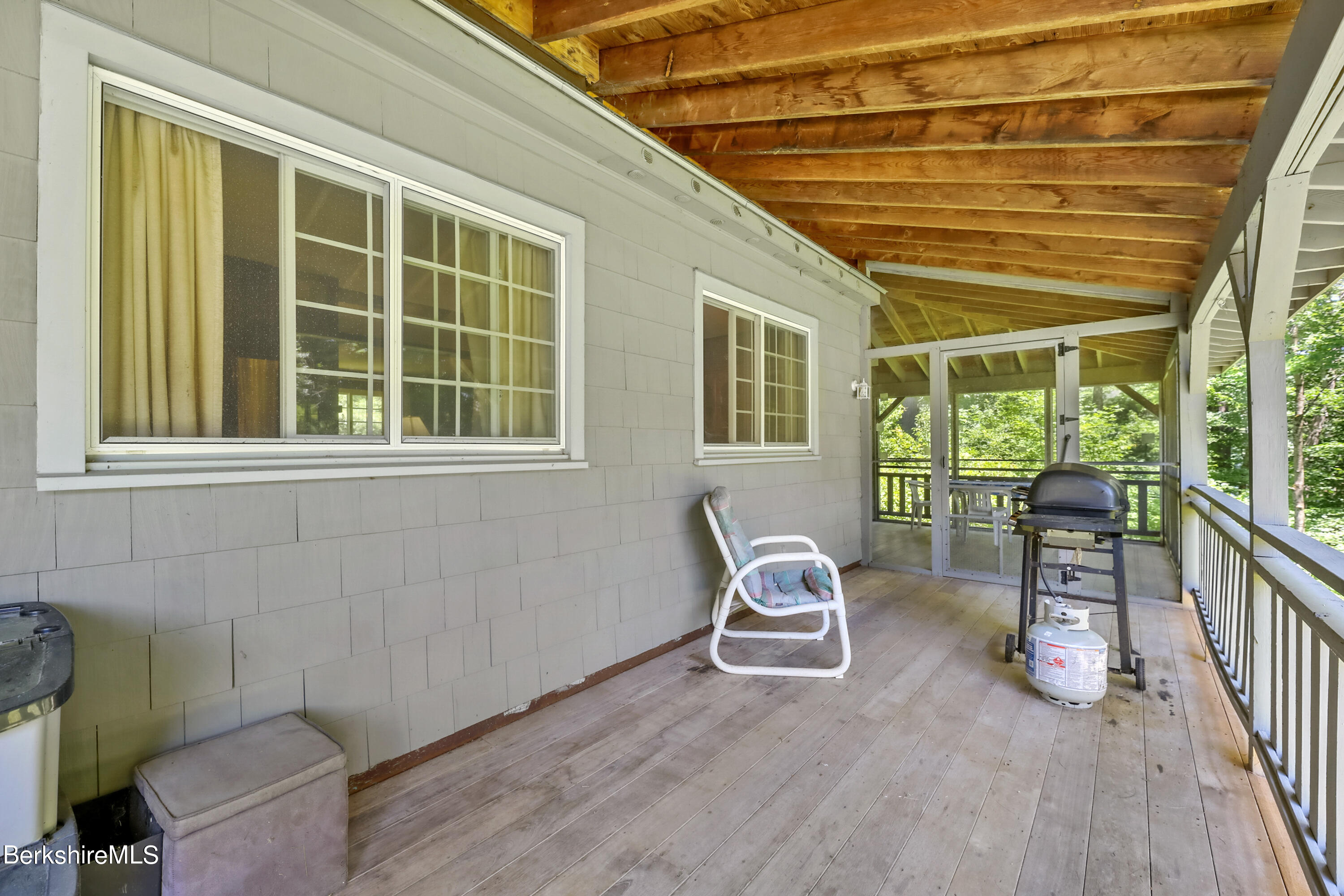2375 North Main Road Otis, MA 01253 - Photo 8 of 31 a view of a house with wooden deck and furniture