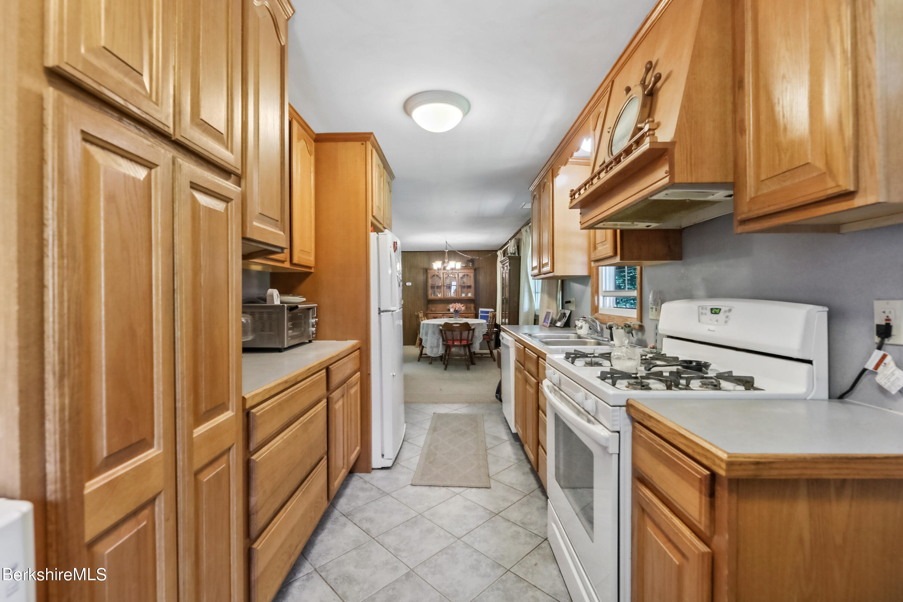 2375 North Main Road Otis, MA 01253 - Photo 10 of 31 a kitchen with stainless steel appliances granite countertop a stove and a refrigerator