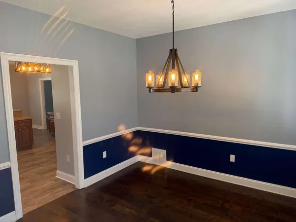 a room that has a bed and a chandelier