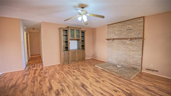 a view of empty room with wooden floor and cabinet