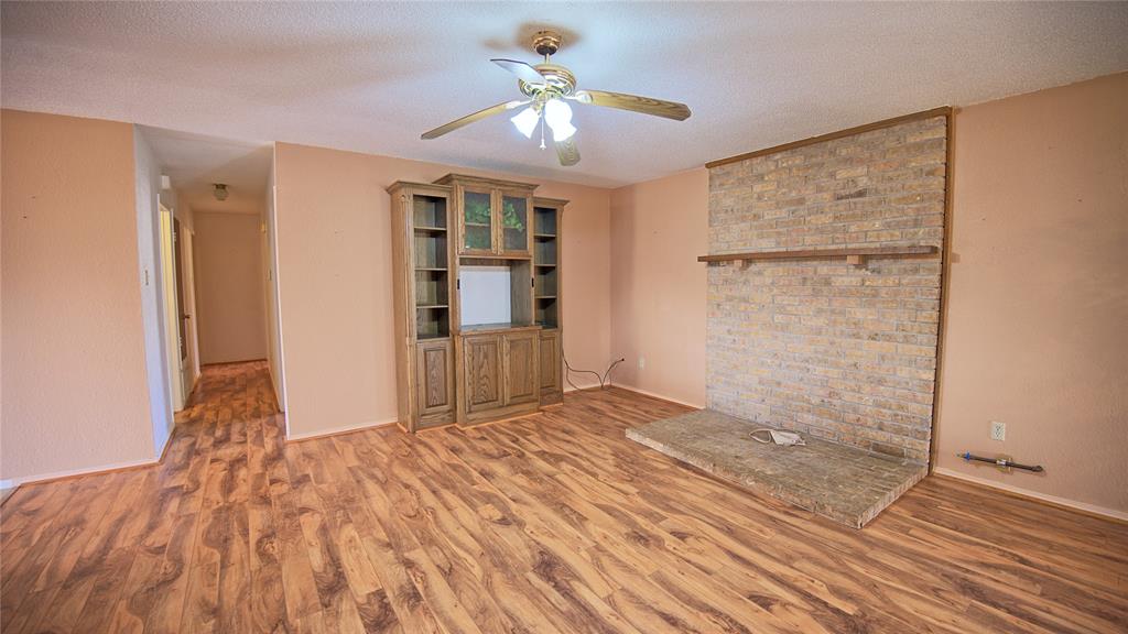 1740 Oakshores Road Nocona, TX 76255 - Photo 11 of 38 a view of empty room with wooden floor and cabinet