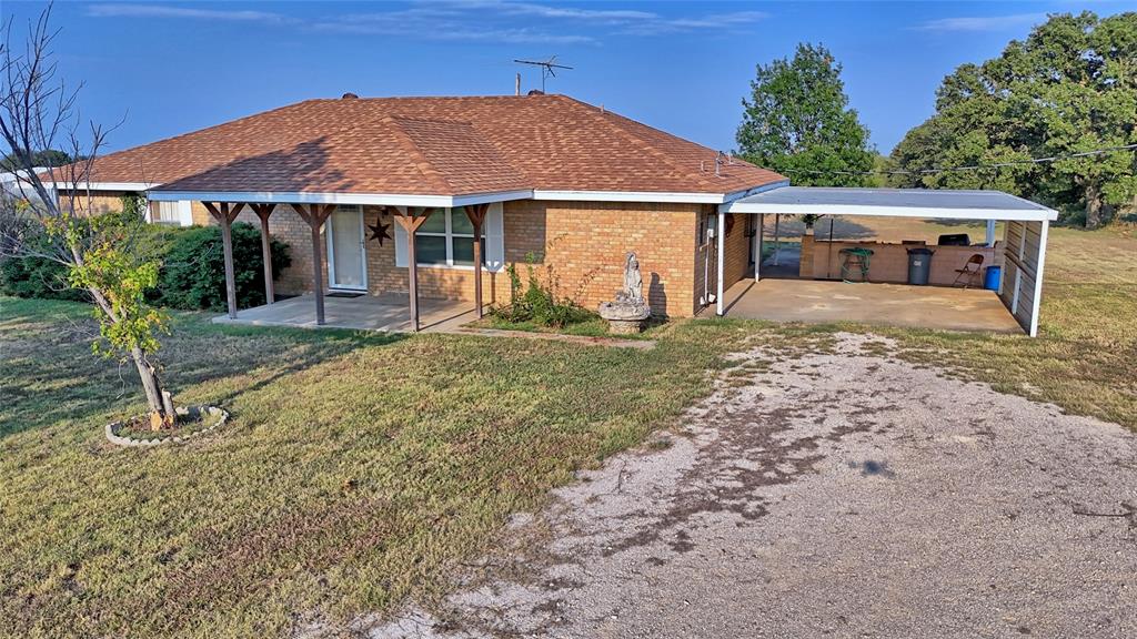 1740 Oakshores Road Nocona, TX 76255 - Photo 17 of 38 a front view of a house with garden