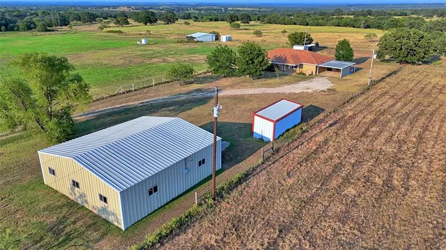 a view of a yard with furniture and garden