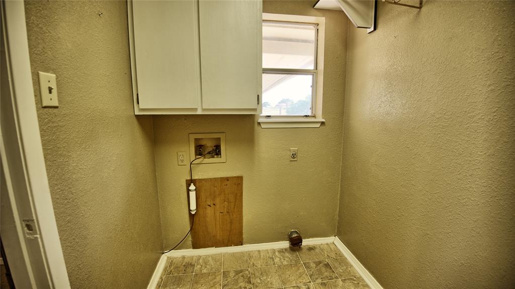1740 Oakshores Road Nocona, TX 76255 - Photo 21 of 38 a bathroom with a granite countertop sink and a window