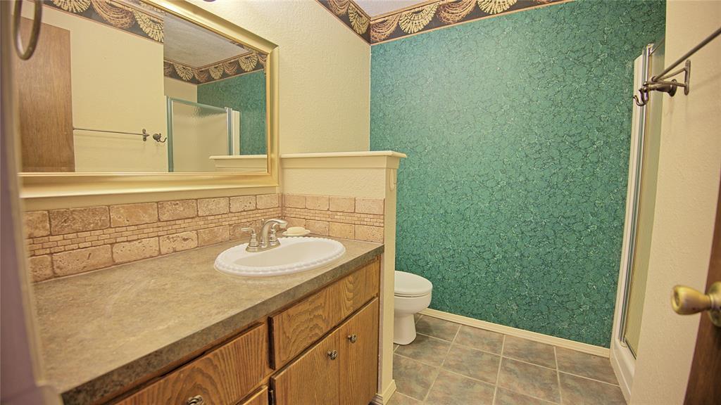 1740 Oakshores Road Nocona, TX 76255 - Photo 24 of 38 a bathroom with a sink and a mirror