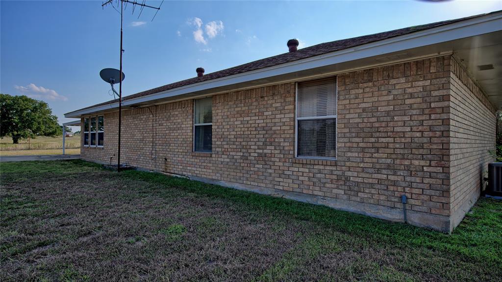 1740 Oakshores Road Nocona, TX 76255 - Photo 30 of 38 a front view of a house with garden
