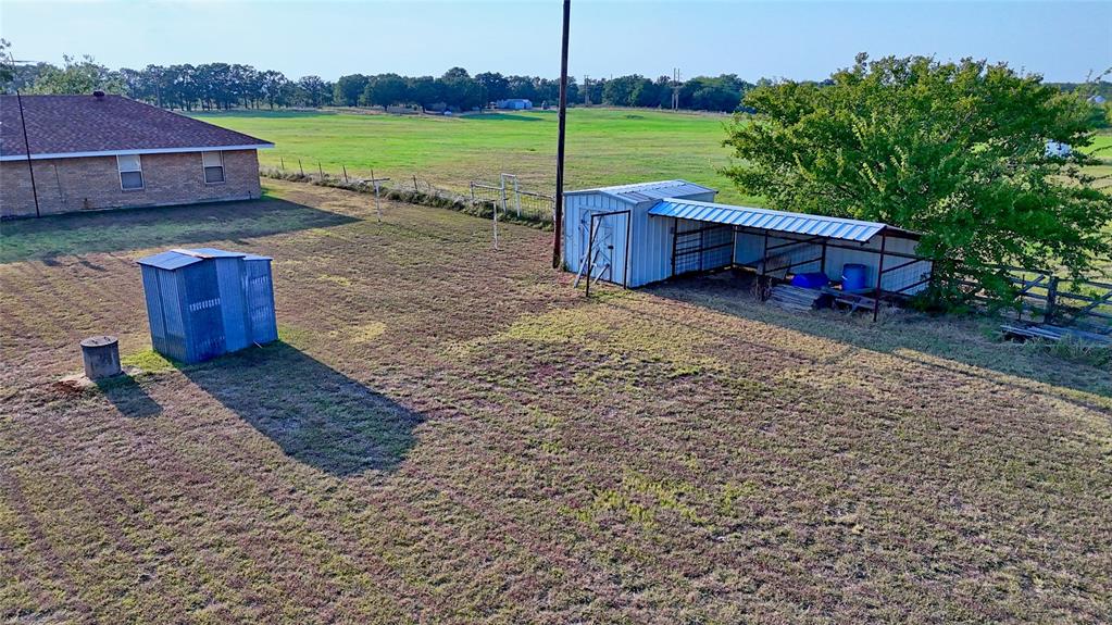 1740 Oakshores Road Nocona, TX 76255 - Photo 31 of 38 a view of a house with a yard and a large tree