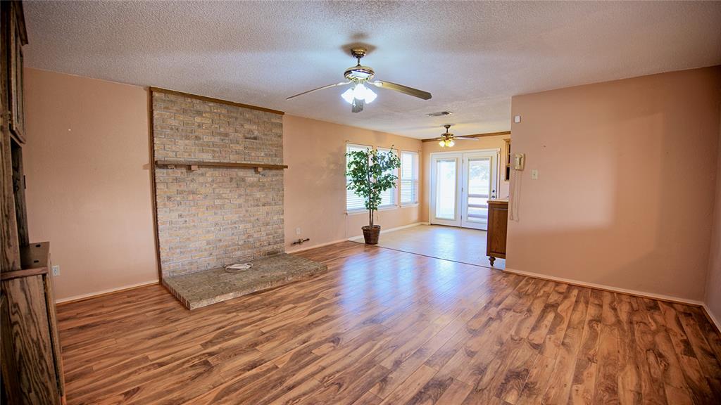 1740 Oakshores Road Nocona, TX 76255 - Photo 5 of 38 wooden floor in an empty room with a window