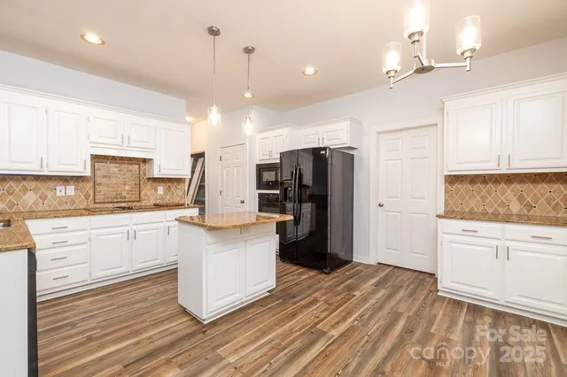 a kitchen with stainless steel appliances a refrigerator sink and stove
