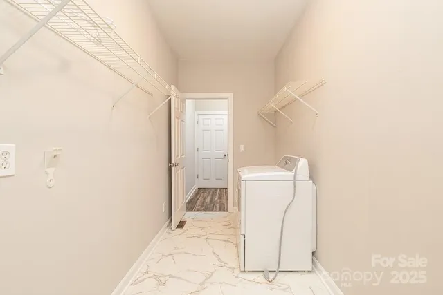 an empty room with wooden floor ceiling fan and windows